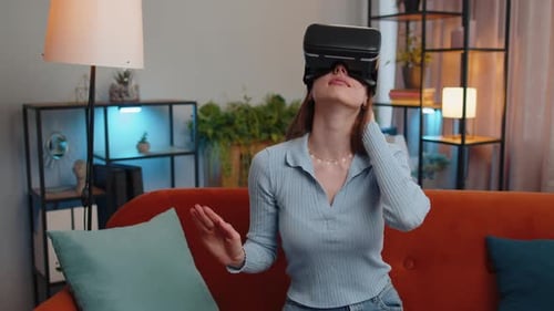 Young Woman Using VR Headset on Couch