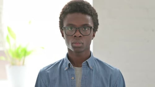 Young Adult Portrait in Glasses and Denim Shirt