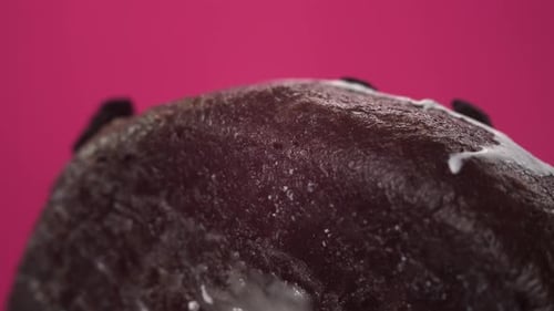 Macro Footage of a Gorgeous Donut Brown Bread. Sweets Close-up with White Cream and Pieces of Dark