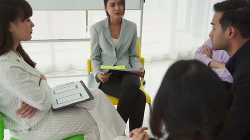 Business People Proficiently Discuss Work Project While Sitting in Circle