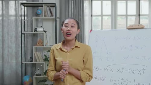 Young Woman Explains Math Equations at Whiteboard