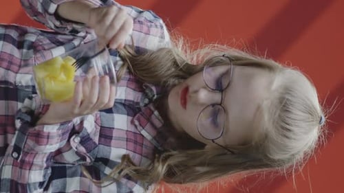 Girl Eating Pineapple Chunks with a Fork