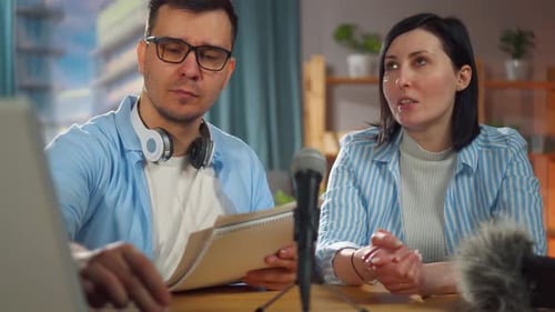 Man and a Woman Sitting in a Home Recording Studio Recording a Podcast Interviewclose Up