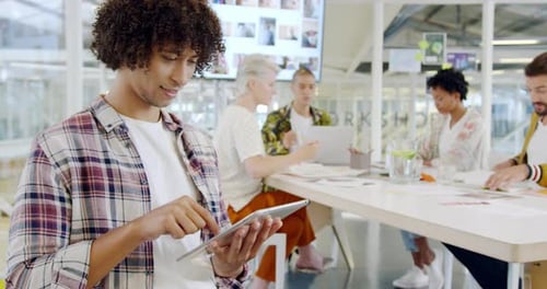Male creative using smartphone in a modern office