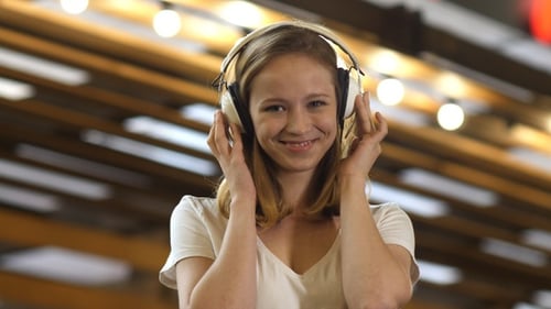 Smiling Woman Listening Music with Headphones