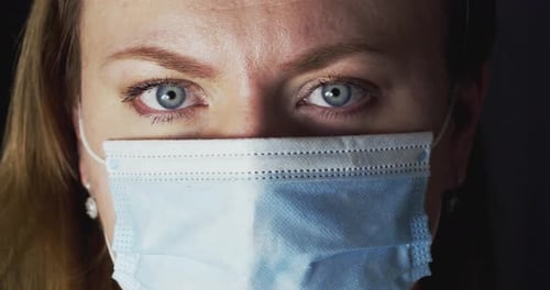 Woman in Surgical Mask Close Up