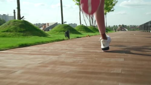 Young Fit Sporty Active Black Woman Running in Sneakers in City Park Outdoors