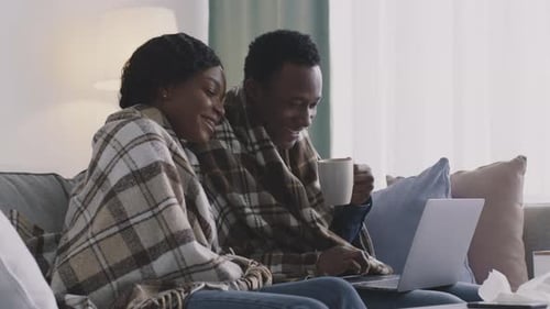 Couple Relaxing Together at Home with Laptop