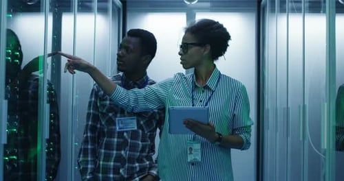 Engineers Inspecting Servers in Data Center