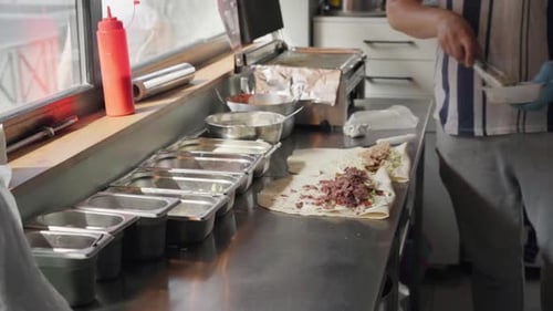 Chef Making a Wrap Sandwich in Kitchen