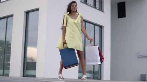 Young Woman With Shopping Bags in Urban Setting