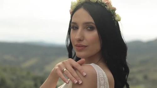 Beautiful and Lovely Bride Standing on the Mountain Hills. Woman in Love
