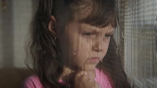 Angry girl by the window.