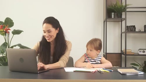 Woman and Child Working at Desk