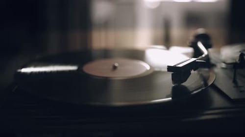 Vintage Vinyl Record Player Spinning in Dark Room