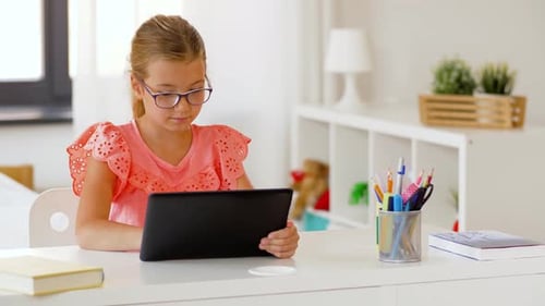 Girl with Tablet at Desk Indoors