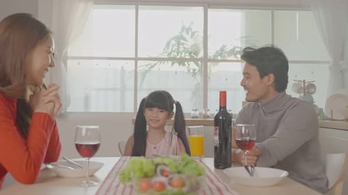 Happy Family Enjoys Dinner Together at Home