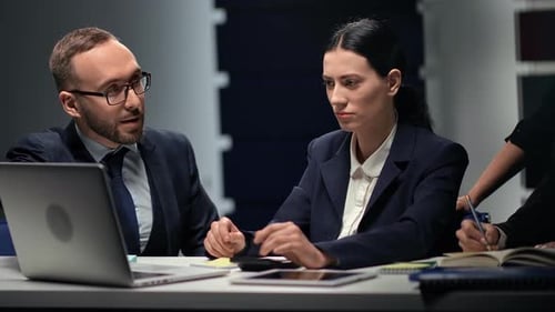 Professionals Collaborate in Workplace Meeting Using Technology