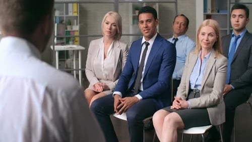 Engaged Audience Applauds Presentation in Corporate Setting