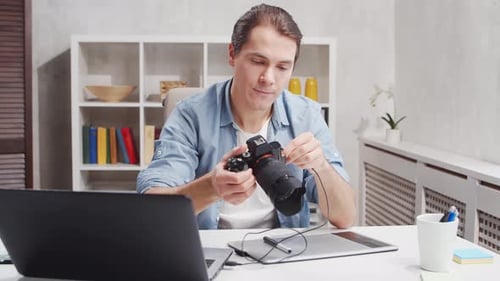 Workplace of freelance worker at home office. Young man works using computer.