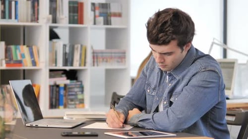 Young Adult Working at Desk in Office