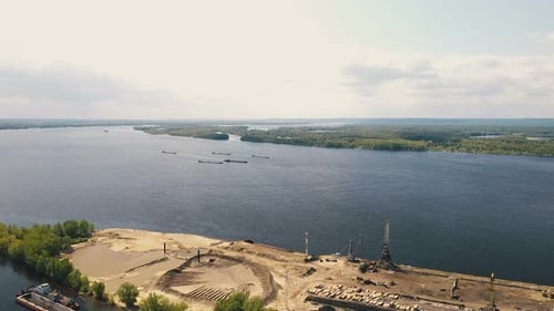 Construction River Port, View From a Quadcopter. Construction Cranes and Equipment Stands on the