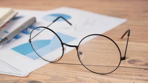 Eyeglass Financial Graph Calculator and Notepad on Table