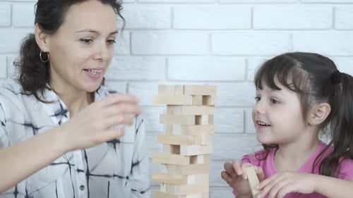 Mother and Daughter Playing Tower Building Game