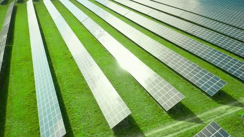 Flight Along Solar Panel on the Green Field. Solar Power Station for Production of Green Energy