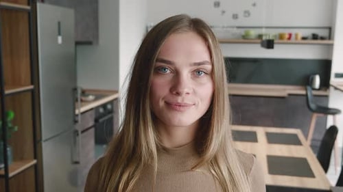 Attractive Blonde Woman Smiling in Modern Kitchen