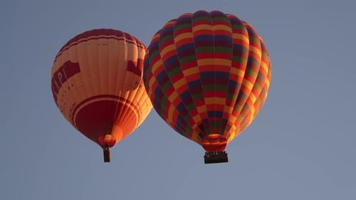 4K Aerial view of Goreme. Colorful hot air balloons fly over the valleys.