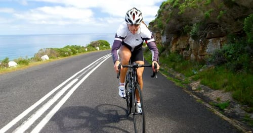 Female cyclist cycling on a countryside road