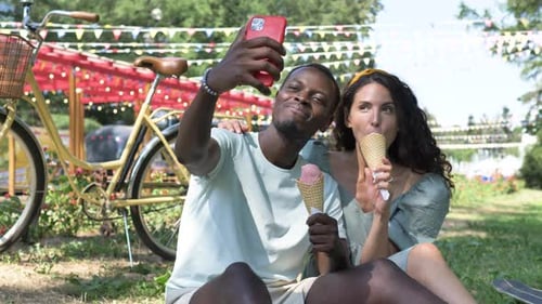Happy Couple Takes Selfie with Ice Cream in Park