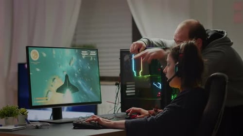 Woman Playing Video Game with Man Assisting