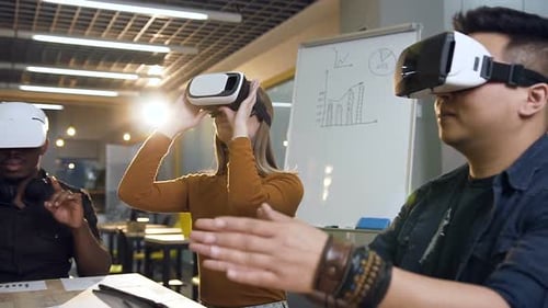 Focused Team of Cowoker Using VR Virtual Reality Glasses