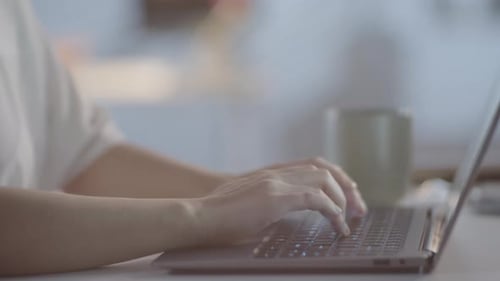 Unrecognizable Woman Working on Laptop in Evening