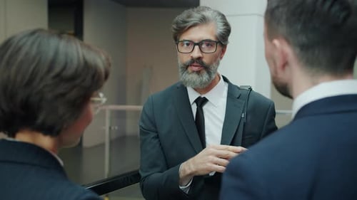 Group of Cheerful People Office Workers Talking Discussing Work in Hallway