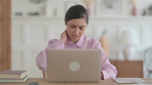 Indian Woman having Neck Pain while using Laptop in Office