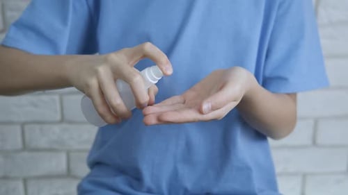 Hand Applying Hand Sanitizer for Hygiene and Health