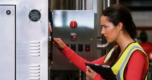 Frau benutzt Maschinen in der Flaschenfabrik