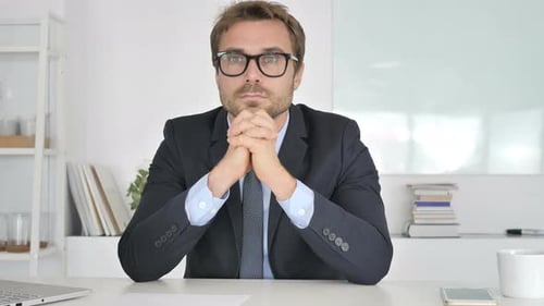 Pensive Businessman Sitting in Office
