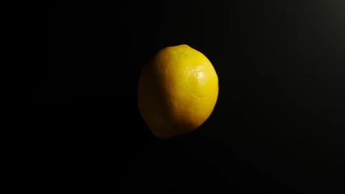 Bright Yellow Lemon Against a Black Background