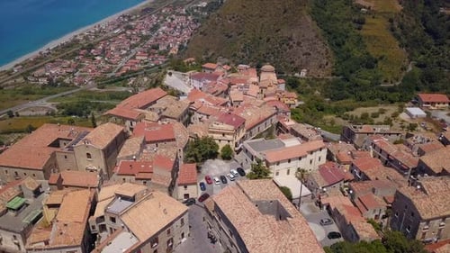 Aerial View of Medieval City on Hill Overlooking the Sea Coast Village and Mountains, Tiled Roofs