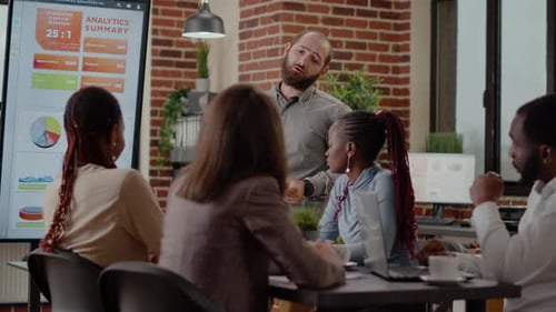 Diverse Team Discussing Business Analytics in Modern Office