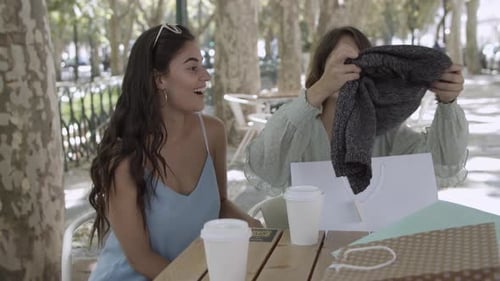 Friends Laughing Together at Cafe after Shopping