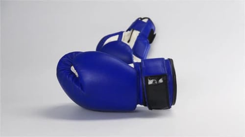 Pair of Blue Boxing Gloves on White Surface