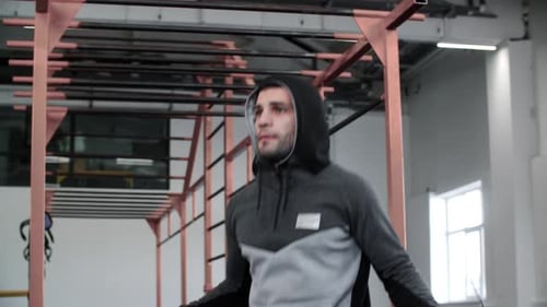 Handsome Athlete Man Jumping on Fitness Rope on Male Workout in Gym