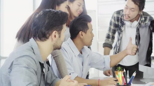 Creative Team Brainstorms Together In The Office