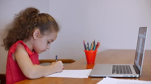 Distance Learning Online Education Schoolgirl Sits at Home at Her Desk Performs a School Assignment
