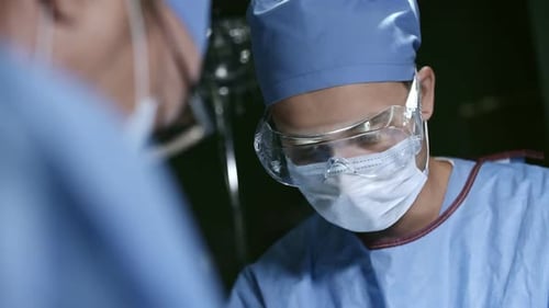 Surgeons Working in Operating Theatre